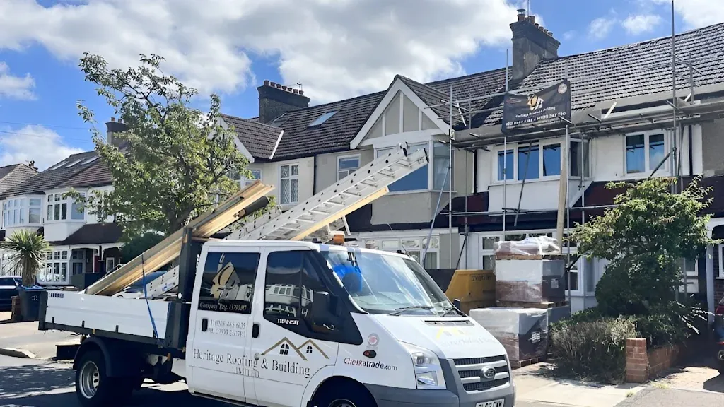 Heritage Roofing van parked outside a house with scaffolding up for a roofing job