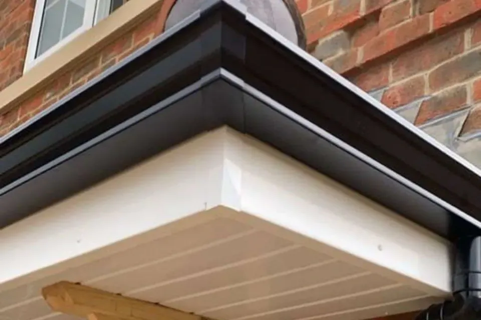 New white fascia and soffit boards with black guttering